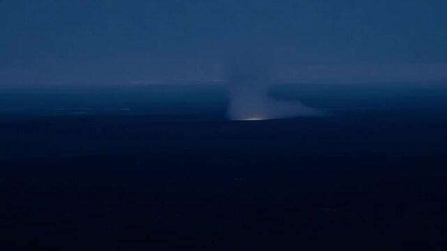Powerful bolt of lightning illuminates the stormy night sky and ocean, showcasing nature's energy and beauty in a dramatic scene of raw power and unpredictability