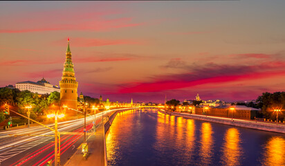 Moscow quay view with Kremlin wall tower during colorful summer sunset in the evening. Famous...