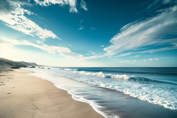 Serene beach with rolling waves and a clear blue sky