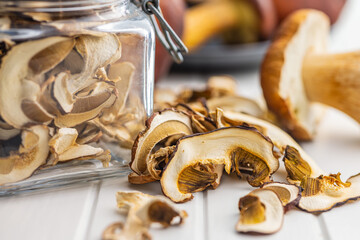 Dried porcini mushrooms. Sliced boletus on white table.