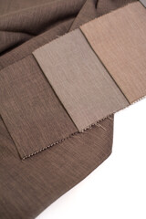 Samples of brown linen fabric for curtains on a white background.