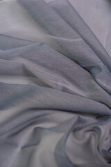 Fototapeta premium Samples of dark gray fabric for tulle. Light and transparent fabric for curtains