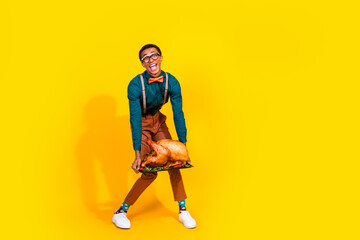 Photo of positive guy hold carry tasty heavy turkey for thanksgiving day party isolated bright color background