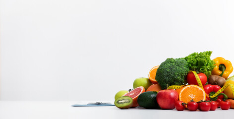 Fresh fruits and vegetables over black ladies dietologist and patient having conversation at clinic