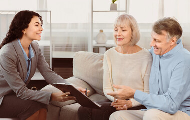 Sign Here Please. Mexican female real estate agent offering home ownership and life insurance to...