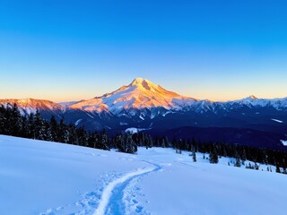 Obraz premium Snow-covered mountains at sunset with trails leading into the scenic landscape
