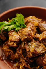 Close up of homemade roasted meat with onions, herbs. Perfect for food blogs, cookbooks, and menus