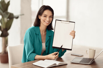 Doing Survey Research. Young woman showing clipboard paperholder working at office, copyspace