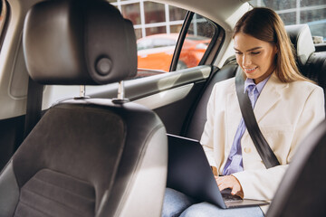 Businesswoman Working Remotely in Car with Laptop on the Go