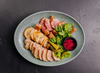 Traditional meat platter with pickles, herbs and beetroot dip on plate. Perfect for gourmet dining