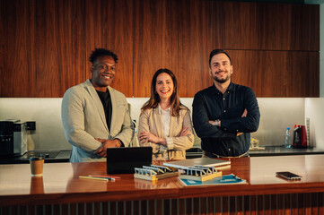 Portrait of diverse team of environmentalists smiling at camera at office