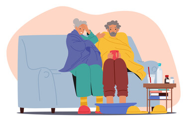 Elderly Couple Sits On A Couch, Feeling Unwell. Both Are Wrapped In Blankets. Woman Holds Her Head