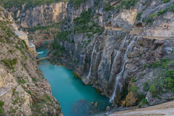 Panorama overlooking a large water dam between the rocks in the mountains