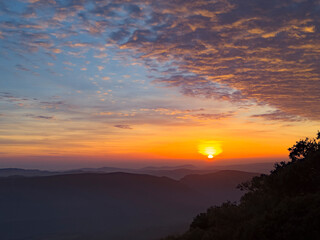 Fototapeta premium Beautiful sunset over the mountains and beautiful clouds around