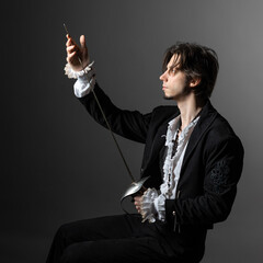 The romantic hero is a duelist in a medieval costume, the style of classical theatrical productions