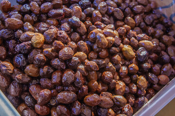 A Bountiful Display of Assorted Olives at a Bustling Mediterranean Market Showcasing Rich Colors and Textures Under the Afternoon Sun