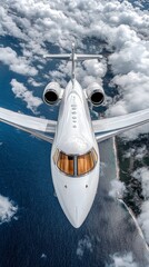 Fototapeta premium A white private jet in flight against a blue sky with white clouds