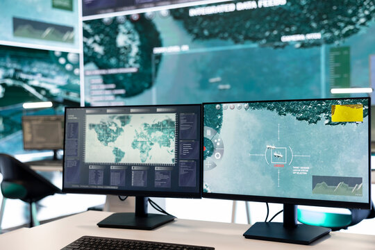 Empty mission control center utilizing radar satellite system to follow surveillance footage and ensure national safety. Army intelligence and reconnaissance military network in power base.