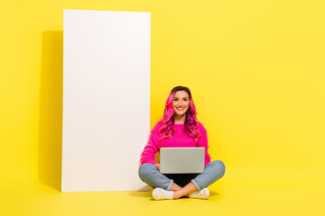 Full length portrait of positive nice person sot floor use wireless netbook big empty space poster...