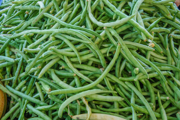 A pile of fresh green beans at a farmers market