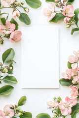 Pink blossoms frame a blank card, perfect for a spring message.