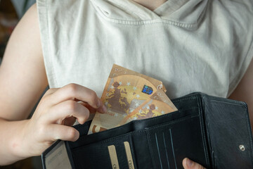child holding wallet, takes out euro, theft money, managing pocket money, encouraging good...