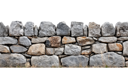 Close-up of a rustic stone wall with irregularly shaped rocks, showcasing natural texture and earthy tones in an outdoor setting.