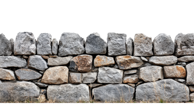 Close-up of a rustic stone wall with irregularly shaped rocks, showcasing natural texture and earthy tones in an outdoor setting.