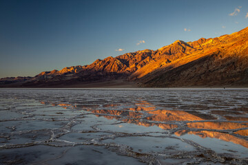 Death Valley California - Sunlit Mountains Reflecting on Badwater Salt Flat 