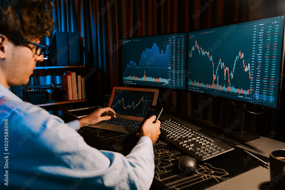 Poster working young business trader focusing on smartphone comparing with laptop in market stock graph in 
