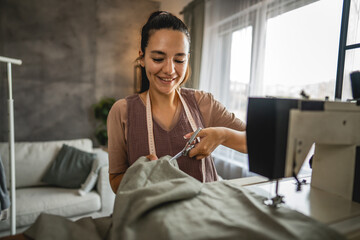 Adult woman fashion designer or tailor hold scissors cut textile