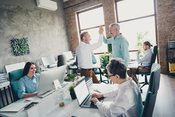 Obraz premium Photo of teamwork people working together unity hands highfive comfortable modern office loft room interior indoors workspace