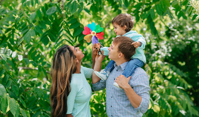 African american family having fun at the park, mother, father is playing with his son. Care or happiness in family