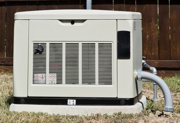 Standby home generator set in residential backyard emergency backup power supply.	