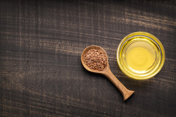 Linum usitatissimum - Organic flax seeds and oil in glass bowl