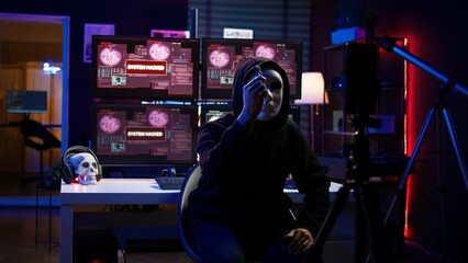 Obraz premium Hacker group member wearing anonymous mask filming video threatening another country government to steal military secrets, doing international espionage in hidden underground base, camera B