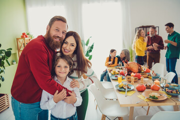 Photo of big family celebrate thanksgiving holiday dinner hugging little son multi-generation relatives living room weekend