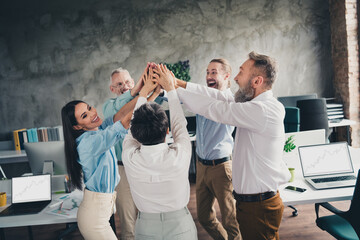 Photo of teamwork people working together brainstorm highfive comfortable modern office loft room...