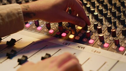 Sound designer manipulating sound effects to enhance tunes on audio recordings, processing and...