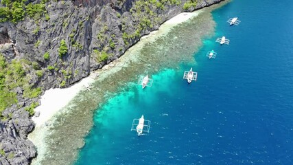 Drone footage of islands, mountains, and beaches captured during an island hopping tour in May at the hidden paradise of El Nido, a tourist destination in Palawan Island, Philippines.