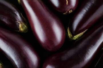 Fresh Ripe Eggplants Arranged on Dark Background, Vegetable Harvest Concept, Top View