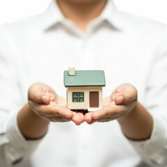 Small house in the palm of your hand, property insurance, safe and wise investment, real estate