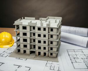New buildings with a shell and construction plans, Construction project model based on paper blueprints, construction site, construction contract