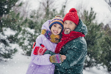 Photo of cute adorable wife husband dressed coats smiling embracing together walking outdoors urban forest park