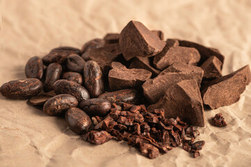 Group of cocoa. Cocoa beans, cocoa mass ,cocoa nips on brown paper background.