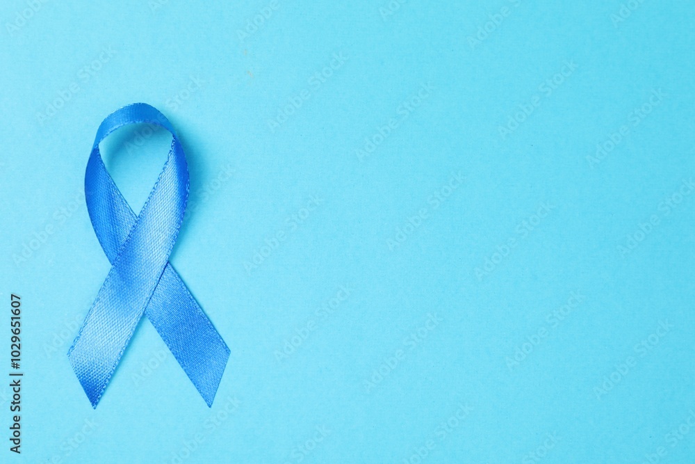 Sticker Blue ribbon on color background, top view with space for text. Prostate cancer awareness