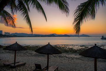 Beach daybeds and the palm trees at Dadonghai beach, Sanya, China
