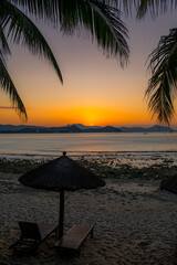 Beach daybed and the palm trees at Dadonghai beach, Sanya, China