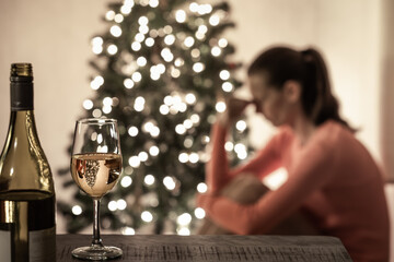 Young woman at Christmas alone at home for the holidays feeling sad, stressed, depresses, lonely 
