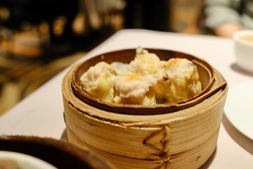 A bamboo steamer of siu mai dumplings (with pork and seafood) at The Eight, a yumcha restaurant at Sydney Chinatown - Haymarket, NSW, Australia